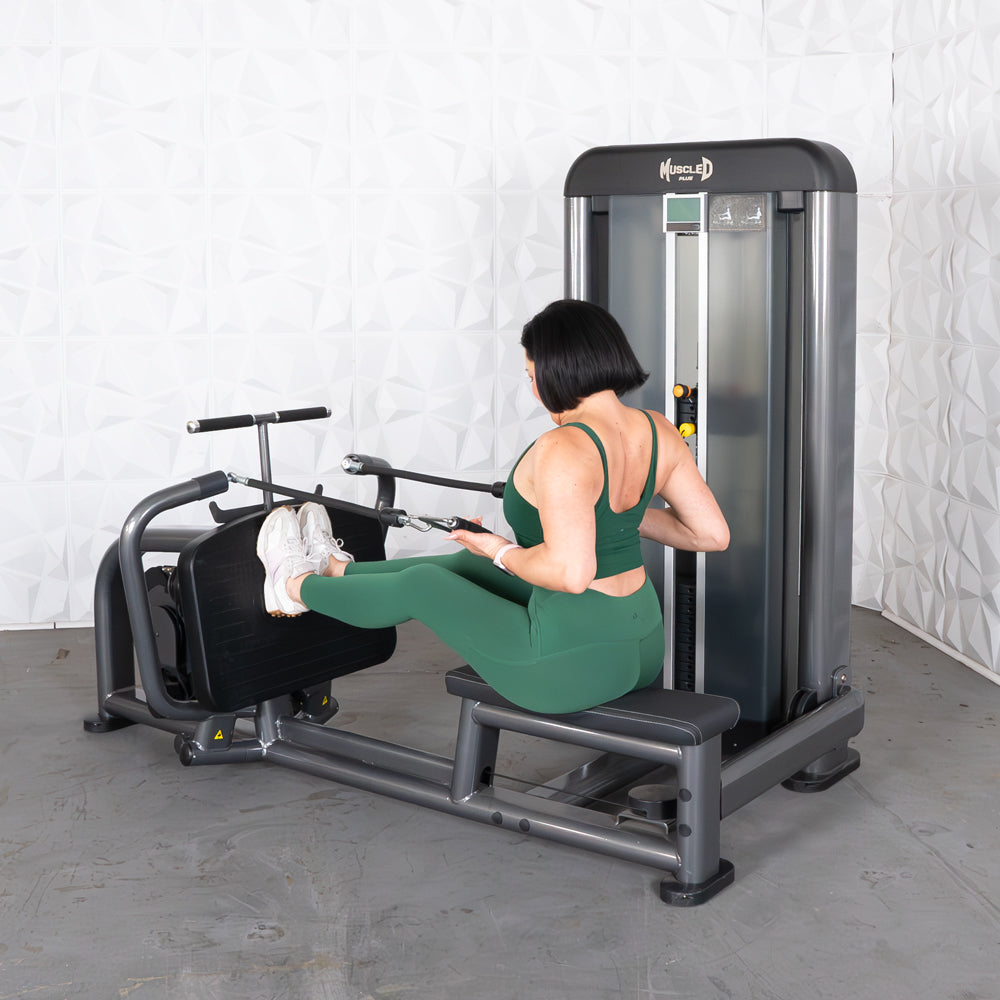 Woman in green activewear using a Muscle D Fitness Elite Plus Long Pull Row machine.