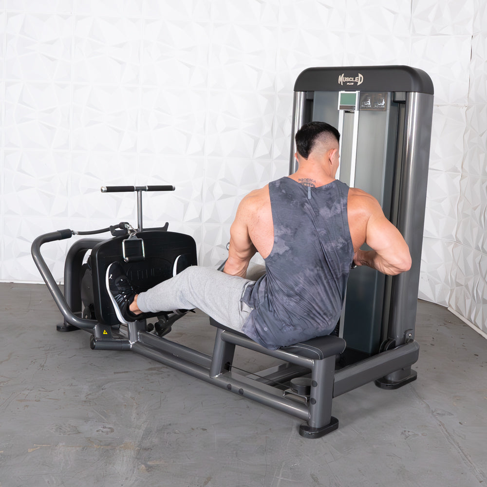 Man in a tank top using a gray and black long pull row machine.