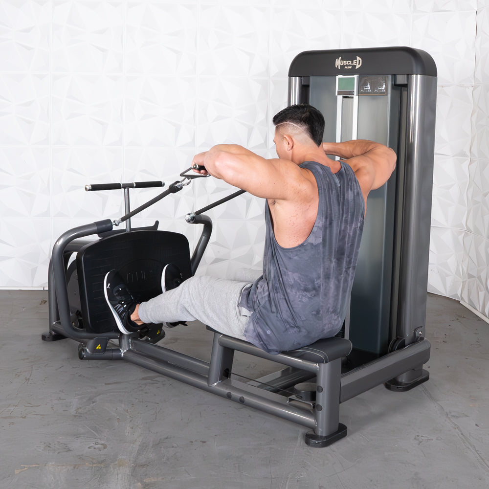 Man in a gray tank top and sweatpants using a seated row machine with a wide grip.
