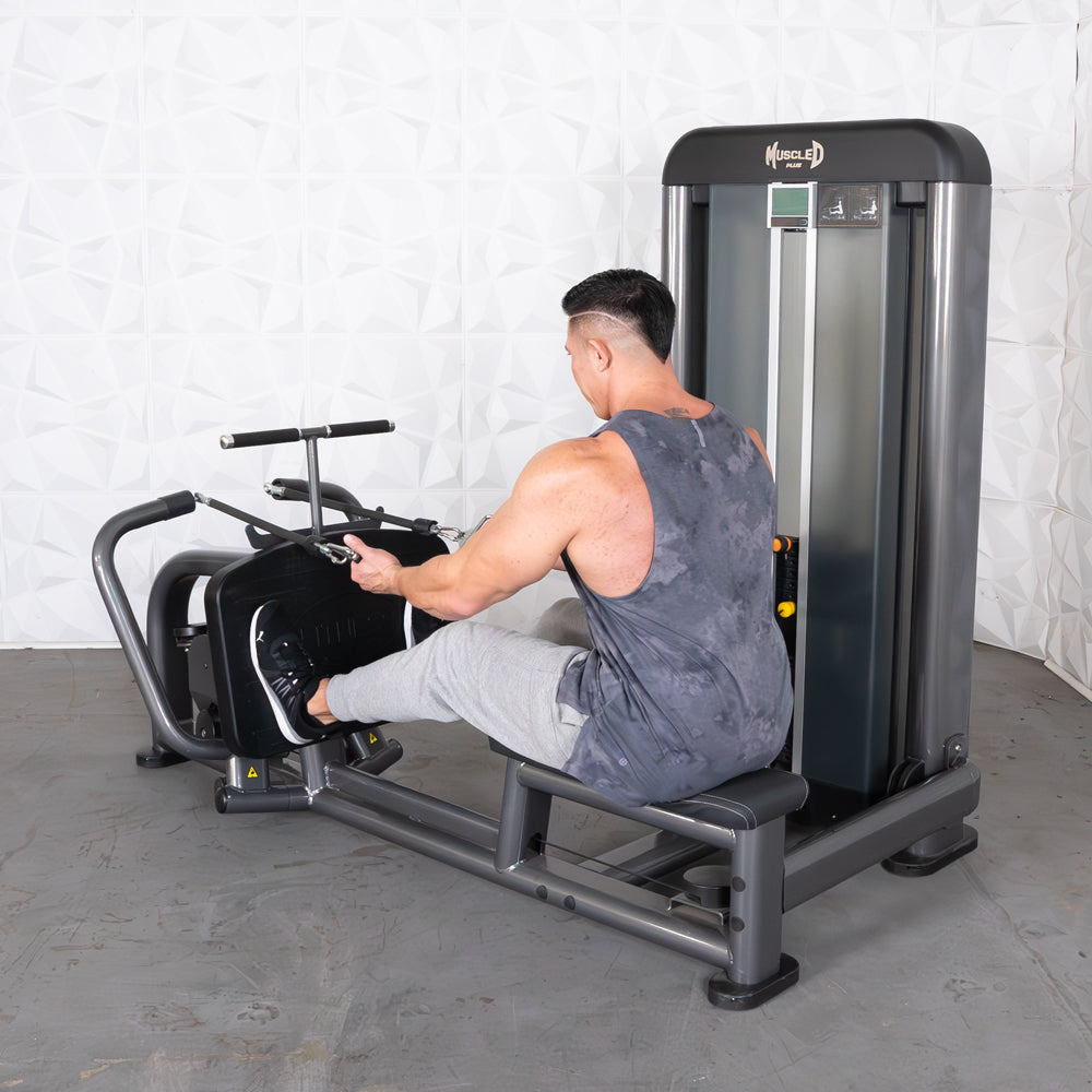 Man performing a seated row exercise on a Muscle D Fitness machine.