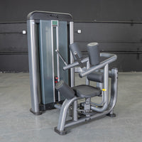 Thumbnail for Gray commercial-grade rotary torso machine with black padded seat and backrests, and a weight stack.