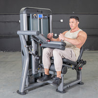 Thumbnail for Man using a seated leg curl machine in a gym.