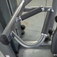Thumbnail for Close-up of the black padded handles and silver frame of the Elite Plus Shoulder Press machine.