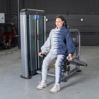 Thumbnail for Woman using a triceps press machine in a gym.