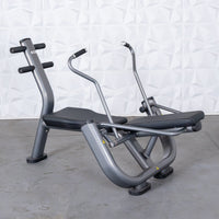 Thumbnail for Gray and black ab roller machine with padded seats and handles on a concrete floor.