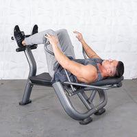Thumbnail for Man in gray tank top and sweatpants using a gray ab roller machine.