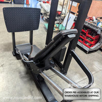 Thumbnail for Black selectorized leg press machine with a diamond plate foot platform and adjustable seat.