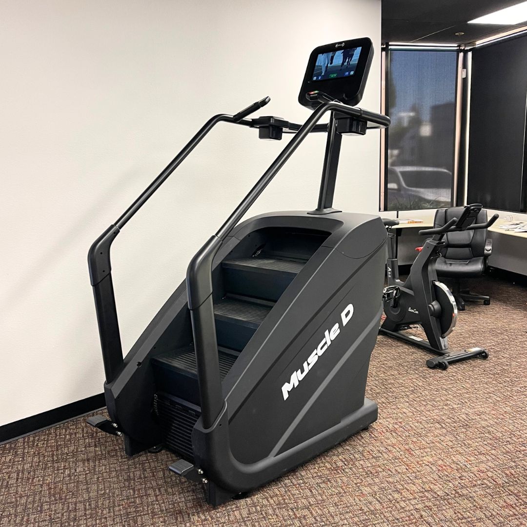 Black Muscle D Fitness stair climber with a touchscreen display and handrails.