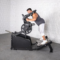 Thumbnail for Man using a black plate-loaded hack squat machine with 45lb weights.