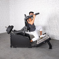 Thumbnail for Man using a black plate-loaded hack squat machine with weights on the back.