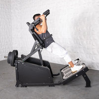 Thumbnail for Man performing a hack squat on a black plate-loaded machine with weights.