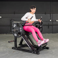 Thumbnail for Woman in pink leggings using a black linear bearing row machine with 45lb weight plates.