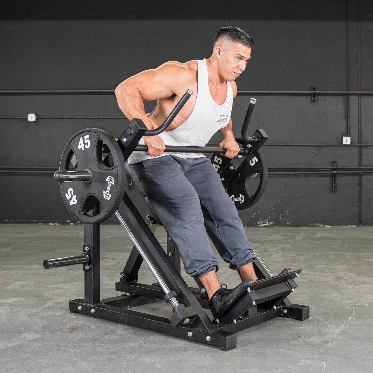 Man using a linear bearing row machine with multi-grip handles and adjustable pad, loaded with 45lb plates.