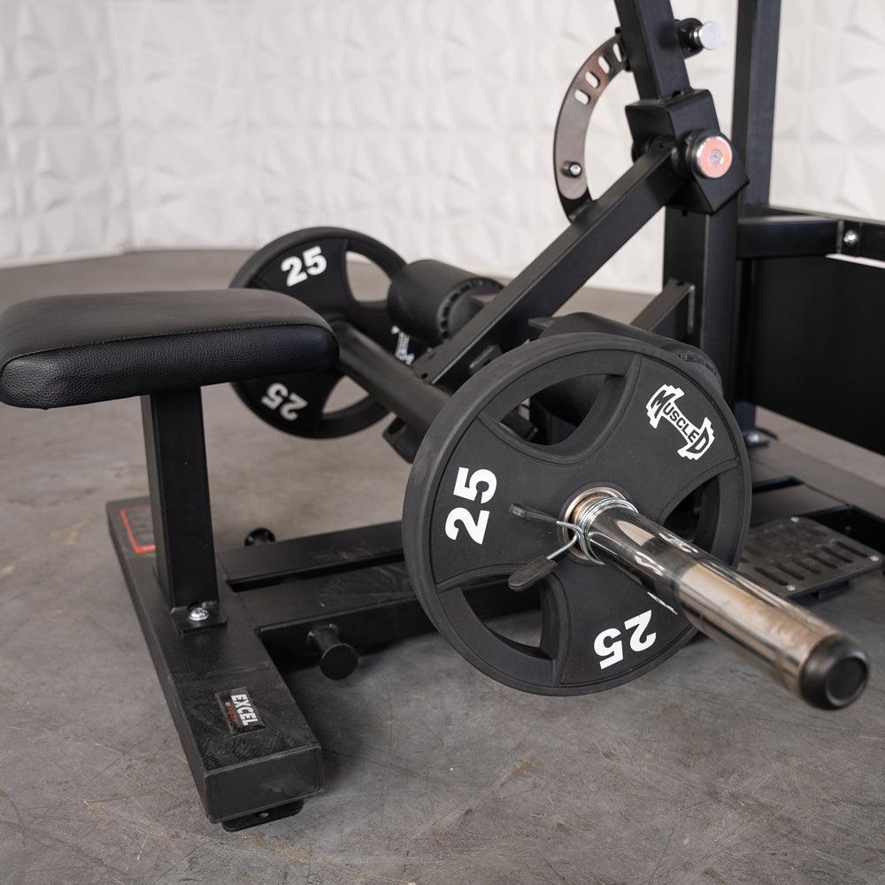 Black hip thrust machine with a padded bench and two 25lb plates on a chrome bar.