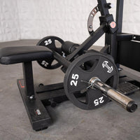 Thumbnail for Black hip thrust machine with a padded bench and two 25lb plates on a chrome bar.