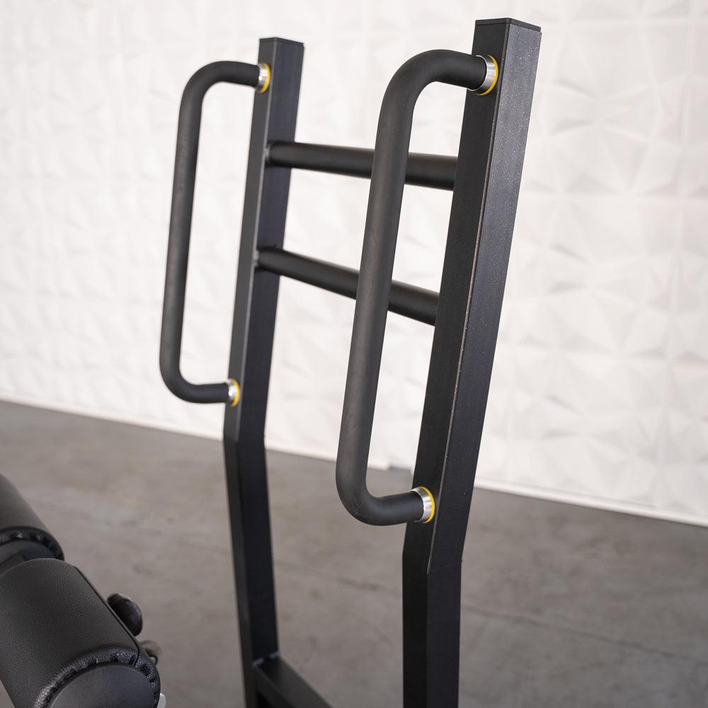 Close-up of the black metal frame and handles of the Excel Standing Hip Thrust machine.