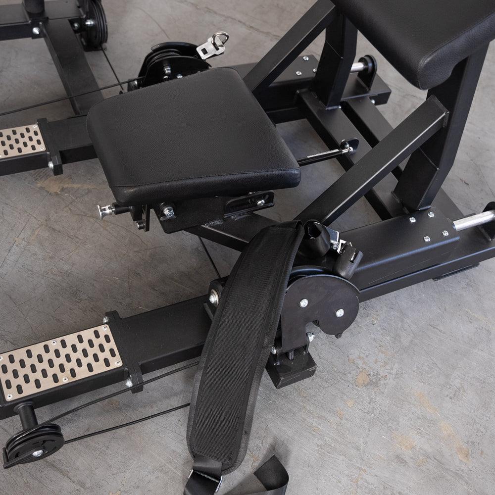 Close-up of a black selectorized hip thrust glute machine with padded seats and a wide strap.