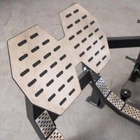 Thumbnail for Close-up of the textured, metal footplate of a glute drive machine.