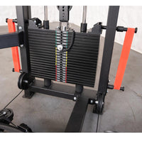 Thumbnail for Close-up of a selectorized weight stack on a black fitness machine with orange resistance bands.
