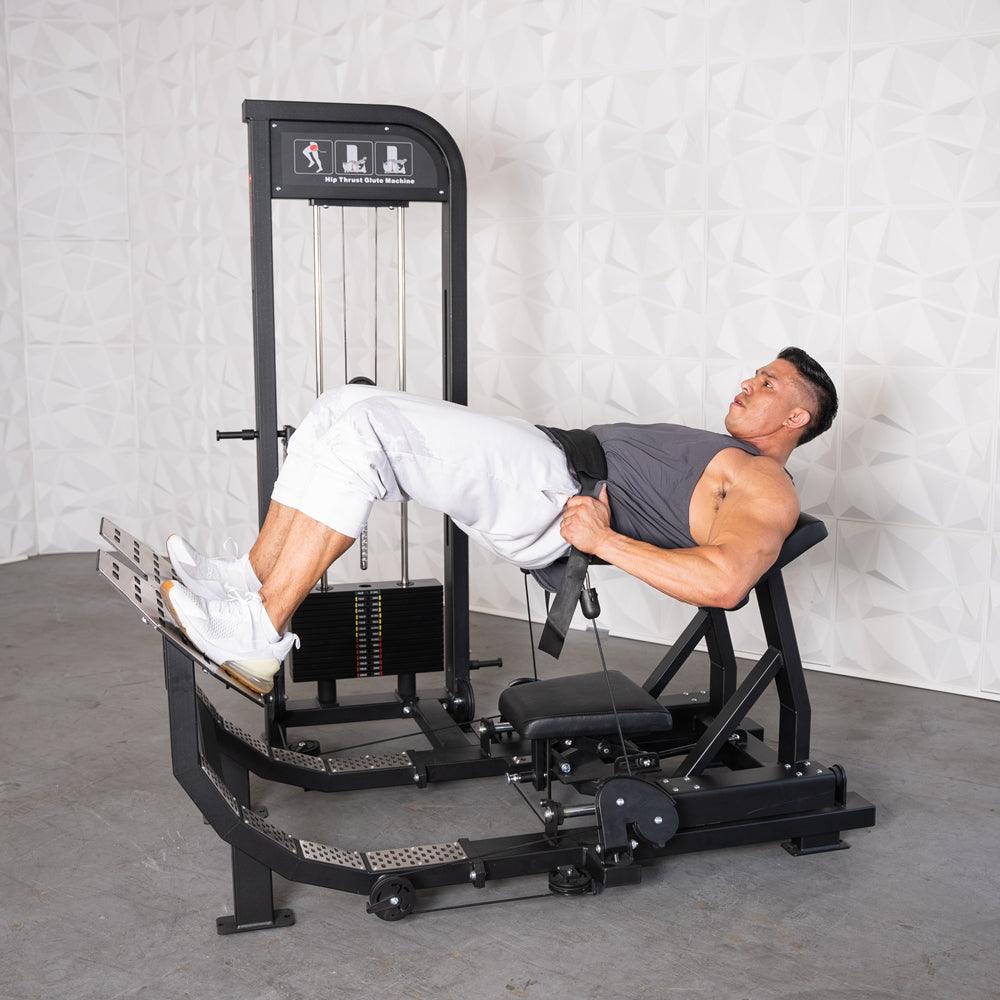 Man performing hip thrusts on a black selectorized glute drive machine with weight stack.