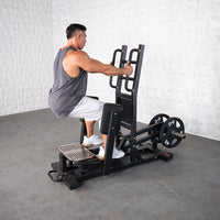Thumbnail for Man using a black plate-loaded standing hip abductor machine with 45lb weights.