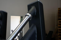 Thumbnail for Close-up of a silver metal rod connecting to a black frame on a leg press machine.