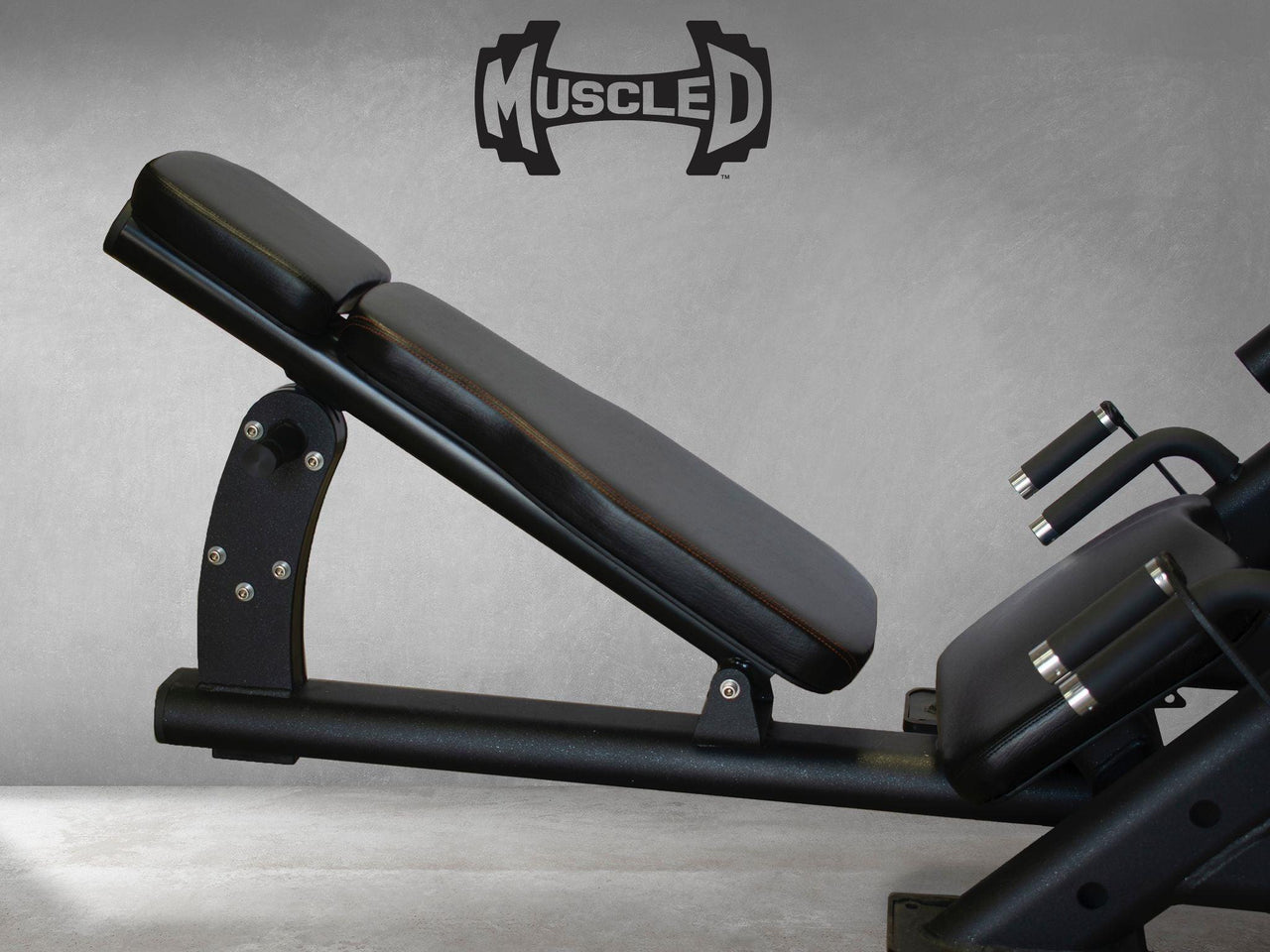 Black leg press machine with an adjustable back pad and handles.