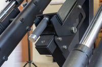 Thumbnail for Close-up of a black leg press machine's adjustment handle and frame, with silver accents and bolts.