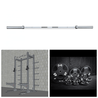 Thumbnail for Silver barbell, grey half rack with J-hooks, and black weight plates in various sizes.