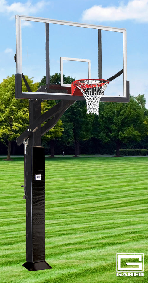 Adjustable basketball hoop with a clear polycarbonate backboard, red rim, and white net on a green lawn.