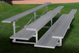 Aluminum 3-row bleacher with double foot plank on a grassy field.