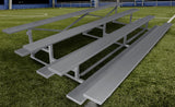 15' low-rise bleacher with 4 rows and double foot planks on a green turf field.