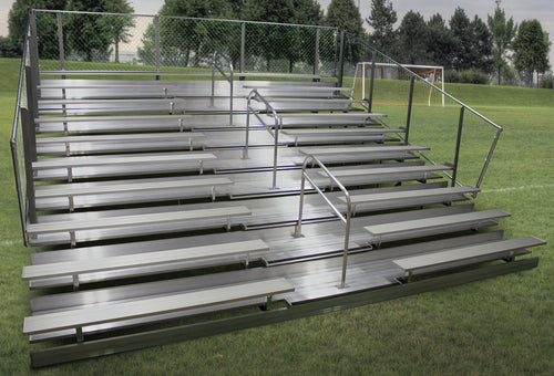 Aluminum bleacher with 10 rows, two aisles, and handrails on a grassy field.