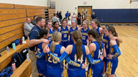 Thumbnail for A basketball team of young women in blue uniforms huddles with their male coach on a wooden court.
