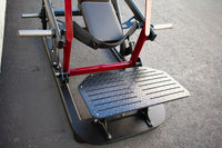 Thumbnail for Close-up of a hip thruster machine with a black footplate, red frame, and padded seat.