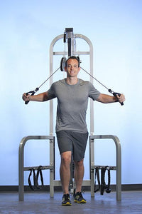 Thumbnail for Man using a gray dual-function high-low pulley machine with handles.