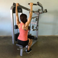 Thumbnail for Woman using a lat pulldown machine, viewed from behind, arms extended upward holding the bar.