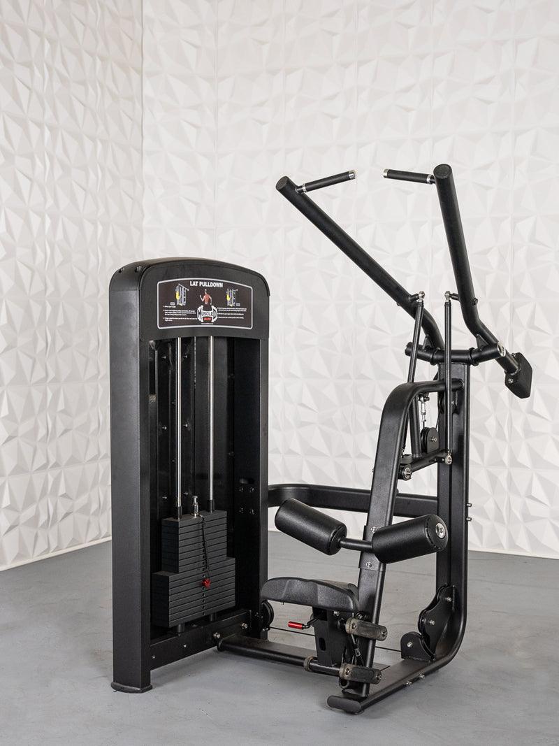 Black commercial lat pulldown machine with weight stack, seat, and adjustable thigh pads against a white textured wall.