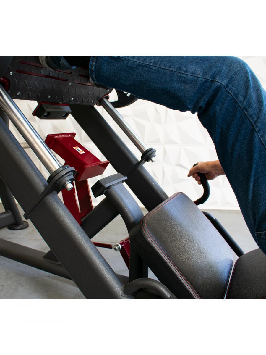 Person using a black and red leg press machine with a padded backrest.