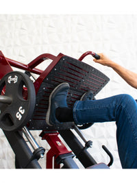 Thumbnail for Person's legs and feet on a leg press machine with a 35lb weight plate.