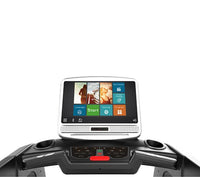 Thumbnail for Close-up of a treadmill's console with a large touchscreen displaying workout options and multimedia.