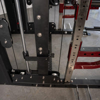 Thumbnail for Close-up of a fitness machine's black and red frame, showing cables, pulleys, and numbered adjustment holes.