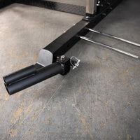 Thumbnail for Close-up of black metal gym equipment base with two horizontal weight plate holders and two vertical bar holders.