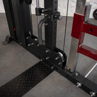 Thumbnail for Close-up of the base of a black and red fitness machine with a diamond plate footrest.