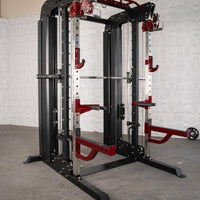 Thumbnail for Black and red multi-functional fitness machine with a barbell, safety catches, and pull-up bar.
