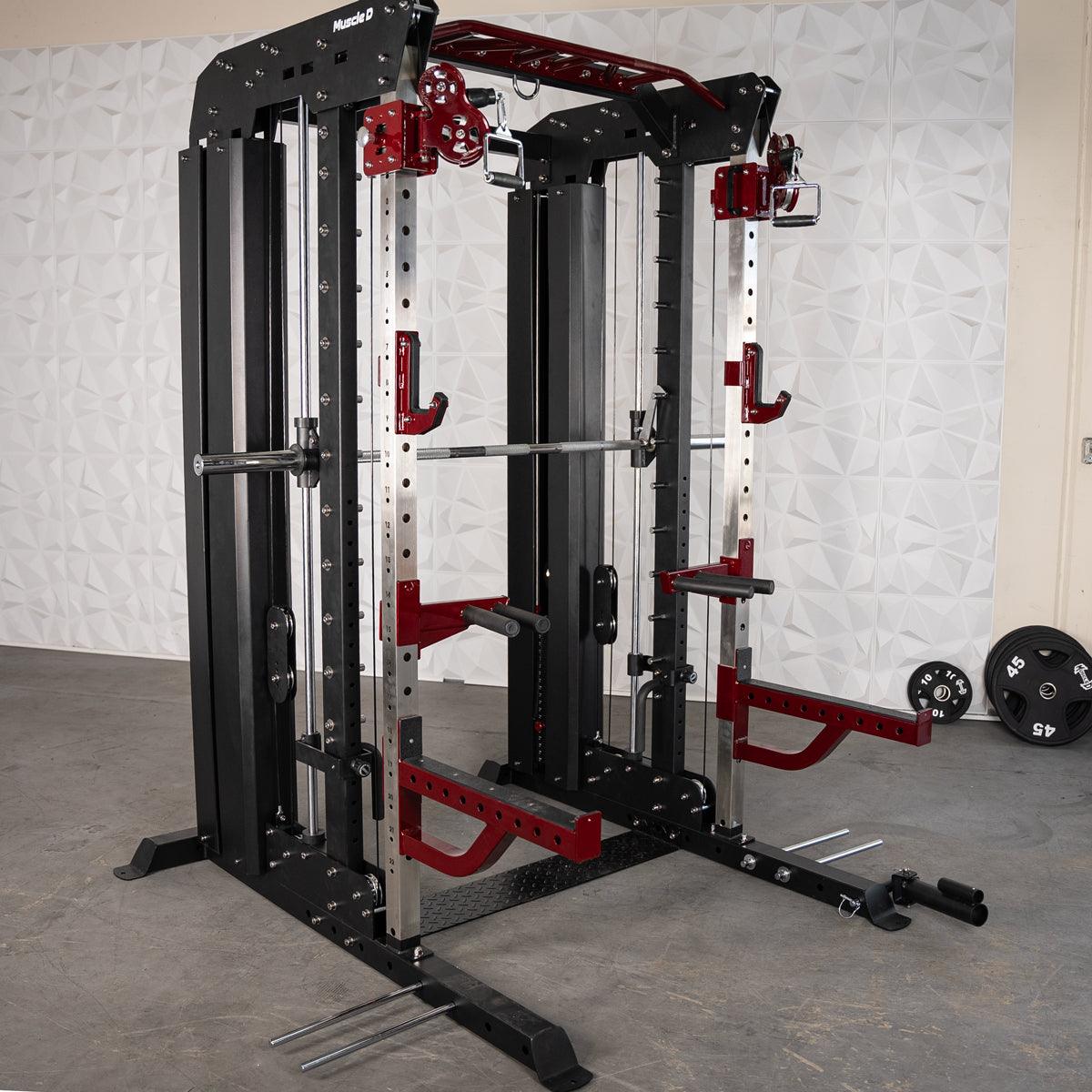 Black and red multi-functional fitness machine with a barbell, cables, and various attachments.