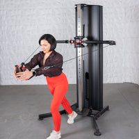 Thumbnail for Woman in red leggings using a black dual adjustable functional trainer for a chest fly exercise.
