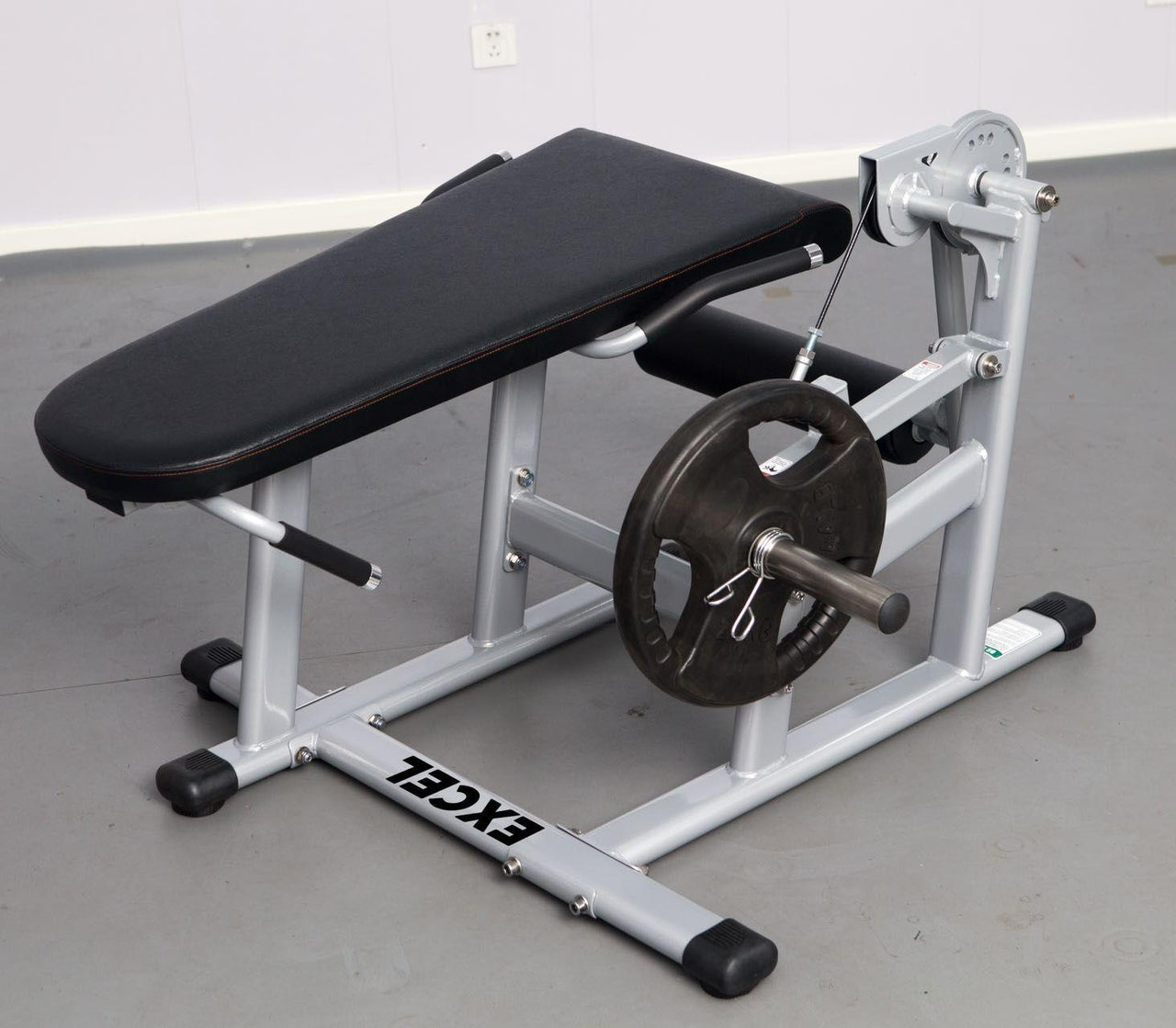 Silver and black plate-loaded leg extension/curl machine with a single weight plate.