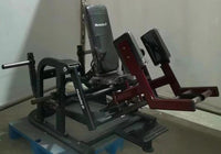 Thumbnail for Black and red Muscle D Fitness plate-loaded abductor/hip extension machine with a padded seat and leg rests.