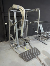 Thumbnail for Silver and black chest press machine with a padded seat and foot platform in a gym.